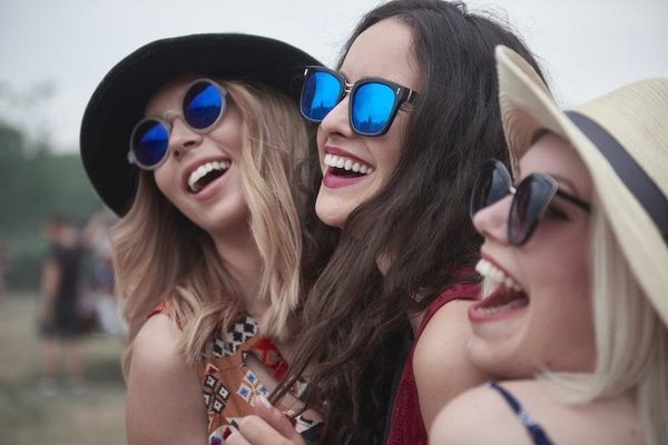 Which music festivals in the UK offer on-site camping facilities?